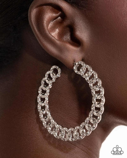 Paparazzi Interlocked Icing - White Rhinestone Silver Link 2 1/2 Inch Hoop Earrings August 2025 Life Of The Party E3054