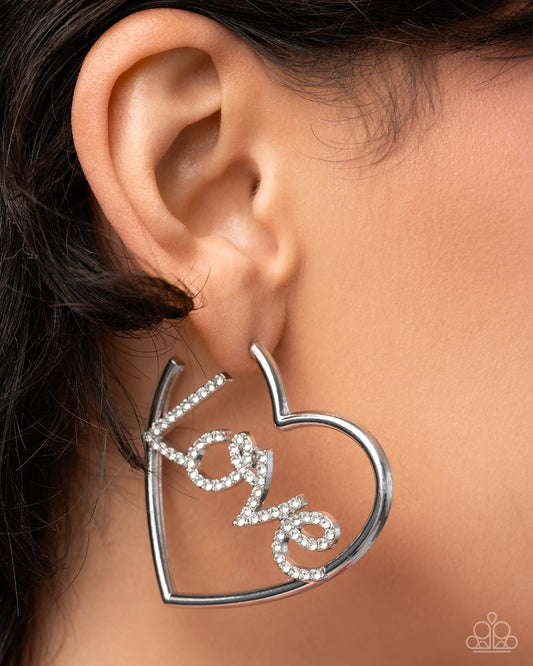 Paparazzi Lovely Cadence White Rhinestone LOVE Heart Hoop Earring Life Of The Party December 2025
