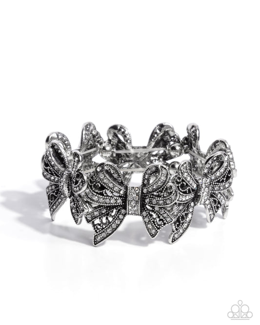 French Flourish - White Rhinestone Bow Stretch Bracelet Life Of The Party October 2024 Paparazzi B1880
