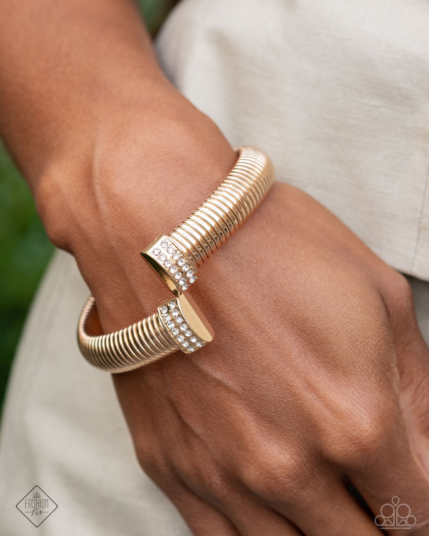 Tailored Transit - Gold Flexible Cuff & White Rhinestone Fitting Bracelet Fiercely 5th Avenue Fashion Fix December 2024 Paparazzi