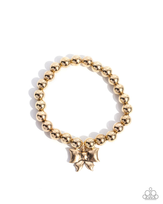Young Lady - Gold Bead Bow Charm Stretch Bracelet Paparazzi B1997