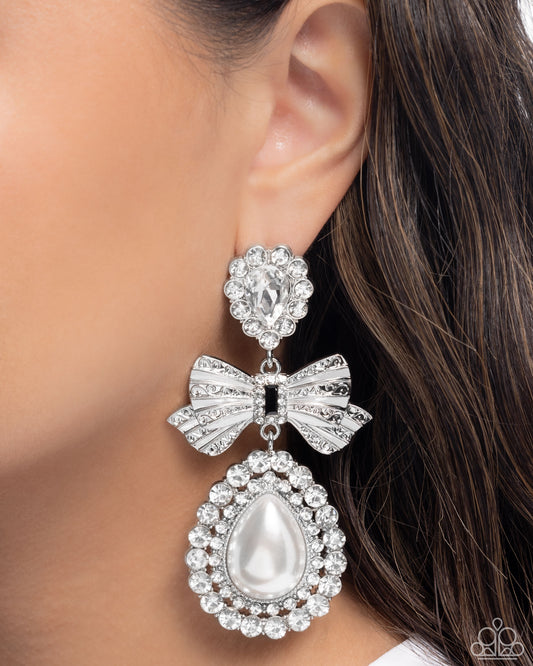 Alluring Aesthetic - White Rhinestone Silver Bow, White Teardrop Pearl Earring Paparazzi E2890