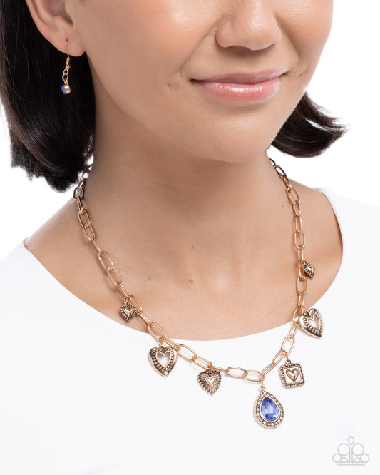 Paparazzi Flirtatious Framing - Blue Teardrop Gem Antiqued Gold Charm Style Necklace